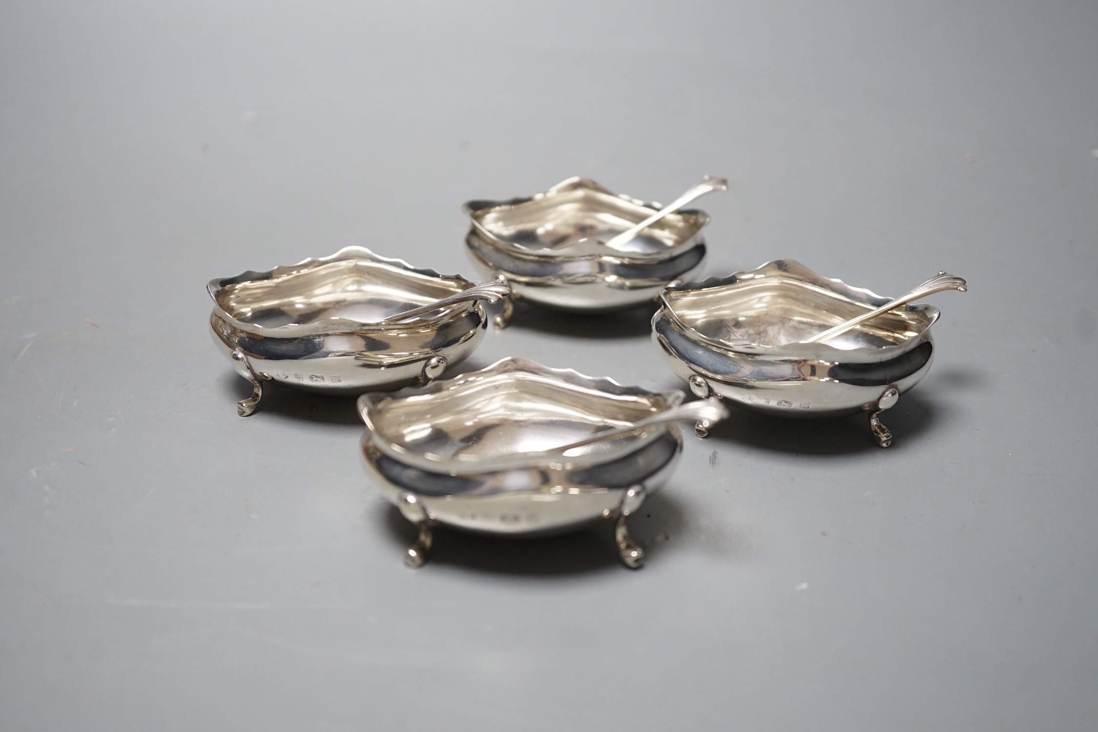 A set of four late Victorian silver oval salts and four matching spoons, Thomas Hayes, Birmingham, 1900, length 59mm.